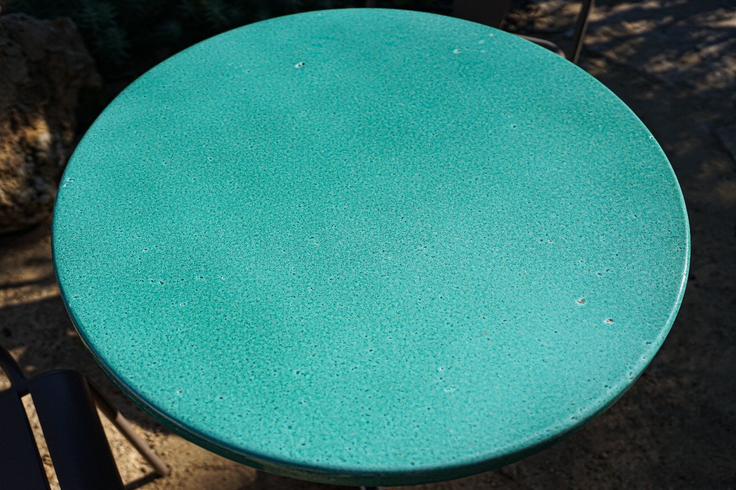 Gros plan sur une table ronde en lave émaillée vert menthe